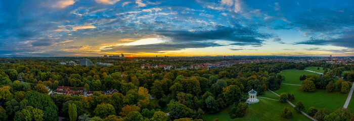 A beautiful start in the day. Sunset over Munichs English Garden as an aerial panorama shot.