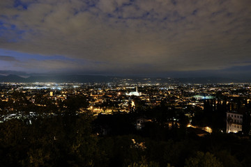 wide night panorama of the city of Vicenza and the famous monument called Basilica Palladiana with the tall Clock Tower. Vicenza, Veneto, Italy - October 3th, 2019