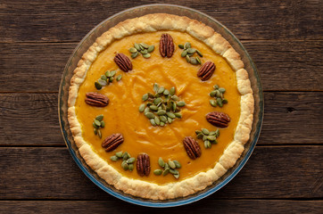 Tasty pumpkin pie, tart made for Thanksgiving day in a baking dish