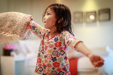 Little cute asian children in their pajamas playing after shower