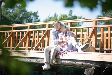 Loving husband hugging wife while enjoying day outdoors