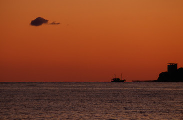 The ship docks at sunset. Beautiful sunset sky.