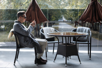 Stylish guy in glasses and a coat.