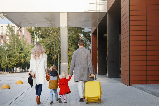 Family with yellow suitcase