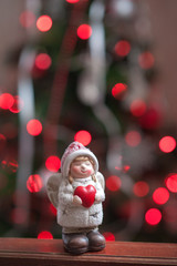 Christmas angel holding a heart in his hands