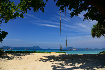 Landscape of clear blue sky of sea and beach with swing for tourist to relax. Taken at Nyaung Oo phee Island, Myanmar.