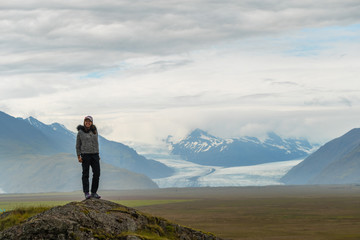 Fototapeta premium Picture of asian woman solo travel enjoy at nature on the top mountain with Skaftafellsjokull glacier as a Background in Iceland