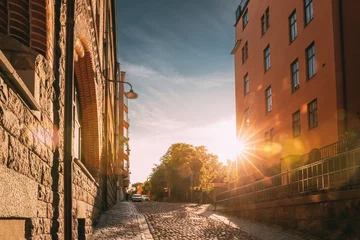 Zelfklevend Fotobehang Stockholm, Sweden. Sunshine During Sunset Above Stockholm Street. Beautiful Street With Multi-storey House In Sunny Summer Evening. © Grigory Bruev