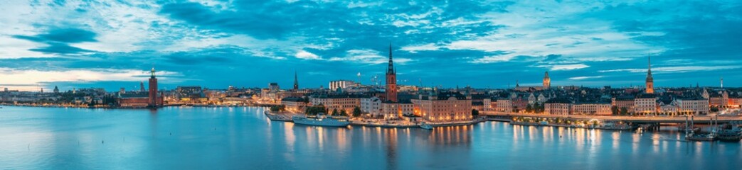 Stockholm, Sweden. Scenic View Of Stockholm Skyline At Summer Evening. Famous Popular Destination Place In Dusk Lights. Riddarholm Church In Night Lighting. Panorama Panoramic View