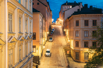 Stockholm, Sweden. Night View Of Traditional Stockholm Street. Residential Area, Cozy Street In Downtown. District Mullvaden First In Sodermalm. Cars Parked In Narrow Street.