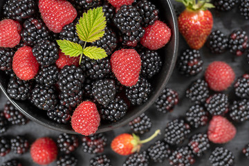 Background from fresh organic blackberries and raspberries, close up. Top view blackberry and raspberry