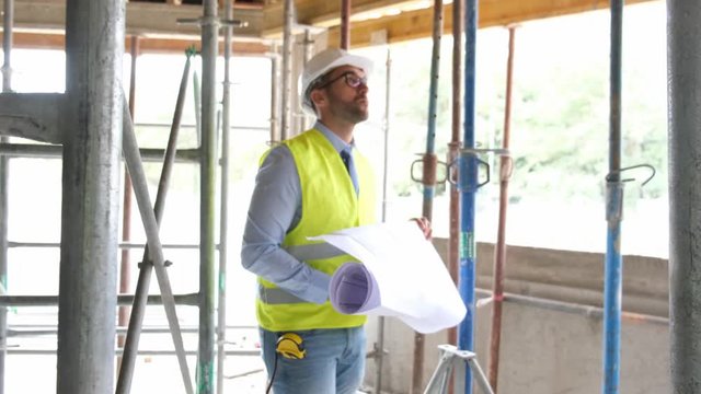portrait of handsome foreman construction worker on a industrial building industry construction site 4 K 50 fps footage