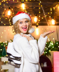 Always in good shape. girl santa hat with skates. Cheerful woman ready for skating. happy new year....