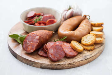 typical smoked portuguese sausages on wooden board