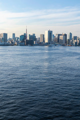 Fototapeta premium View of the Tokyo Bay during the day from the Rainbow Bridge in Odaiba. Busy waterway with ships. Landscape Orientation.