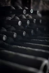  Old dusty wine bottles in a dark basement © bizoo_n