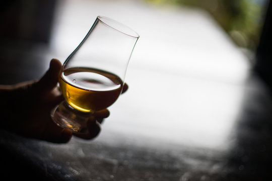 Hand Holding A Glencairn Whisky Glass