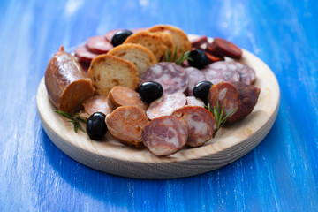 typical smoked portuguese sausages on wooden board