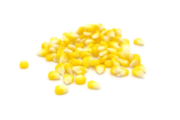 Piles of fresh corn kernels close-up isolated on white background