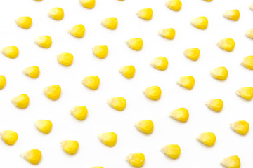 Fresh corn kernels neatly arranged pattern on white background