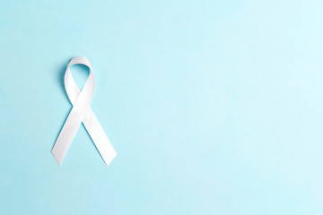 Lung cancer awareness ribbon on blue background.