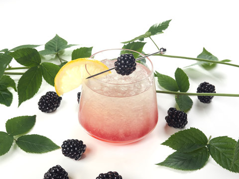 Bramble cocktail. A gin sour cocktail spiked with an eye-catching shot of blackberry liqueur