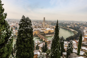 Verona cityscape in winter with snow (UNESCO world heritage site), the river Adige with the Ponte...