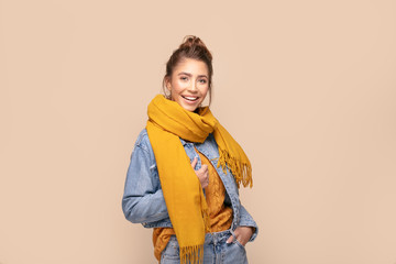 Happy girl in autumn yellow scarf.