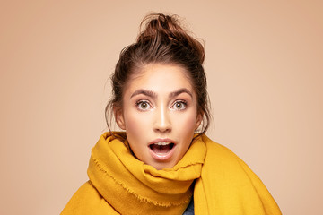 Happy surprised girl in autumn scarf.
