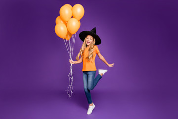 Full length photo of little witch lady halloween party holding many air balloons excited chilling...