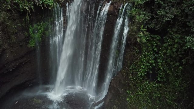 Tilt Up Aerial of Amazing Tiu Kelep Cascade Waterfall in Jungle of Lombok Island Indonesia, Under Mount Rinjani