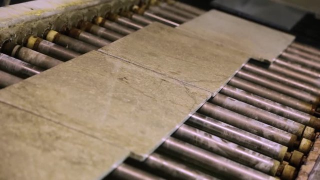 Natural stone tiles manufacturing. Polished tiles on the production line