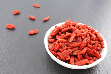 dried goji berries in a small white bowl