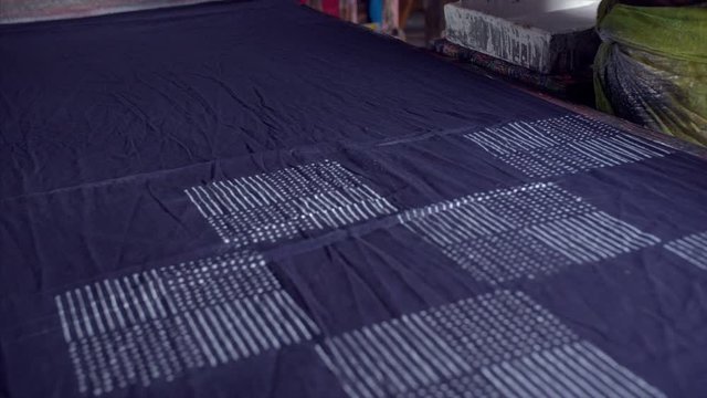 A block printing artist working at a textile workshop. 