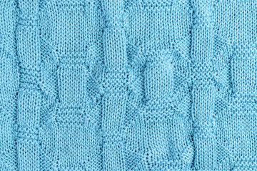 Fototapeta premium Knitted light blue background. Knit needles pattern.