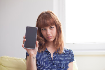 Naklejka premium Woman showing mobile phone screen
