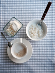 White cup of coffee with milk and rice porridge 