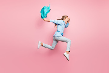 Fototapeta na wymiar Full body profile photo of pretty little lady jumping high rushing home after studying week wear pupil backpack casual sweater clothes isolated pink color background