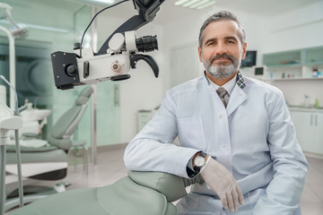 Professional male dentist looking at camera and smiling