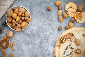 Mix of nuts - hazelnuts, almonds, walnuts in a basket over dark bckground. Healthy super food. Top view with copy space.