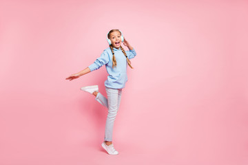 Fototapeta na wymiar Full length body size photo of cheerful nice cute funny blonde haired girl screaming her favorite song dancing in earphones wearing sport wear hoodie sweater blue isolated over pastel color background