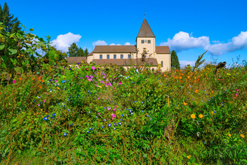 Fototapeta na wymiar St. Georg Church on Reichenau Island has been standing here for over 1000 years. There are no buildings from this time in the distance after destructive forces of all kinds. Like a rock of love.