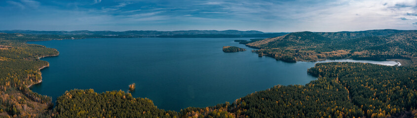 Aerial panoramic view of purest water of Turgoyak lake; popular tourist destination, resorts and holiday camps; anthropogenic impact affects on water quality and ecological system; Miass, Ural, Russia