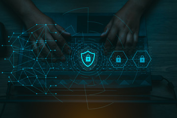 Person using a laptop computer with cyber protection and safe for global network security concept.