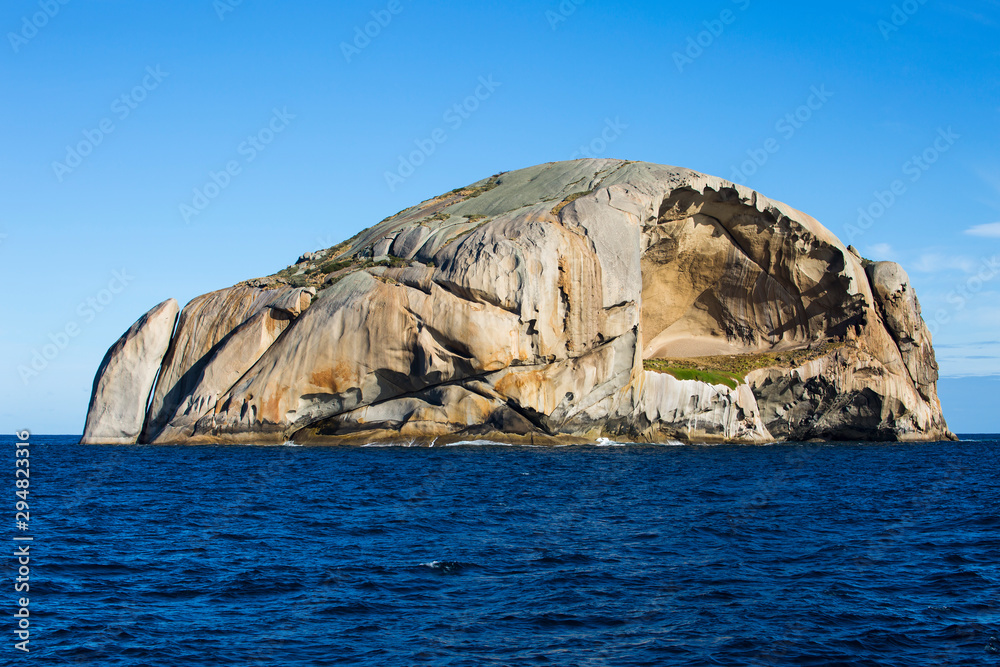 Wall mural cleft island, better known as skull rock, is a solid granite monolith in bass strait near wilsons pr