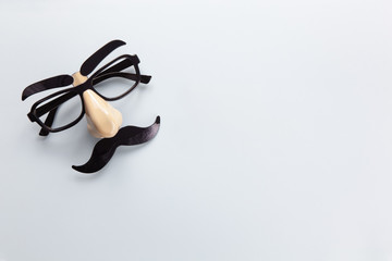 Carnival mask with moustache, nose and glasses on grey background, copy space. Concept Movember,...