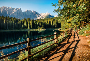 Captivating summer view of Carezza (Karersee) lake. Awesome morning scene of Dolomiti Alps, Province of Bolzano, South Tyrol, Italy, Europe. Beauty of nature concept background.