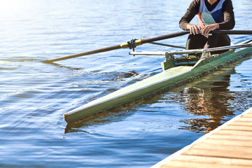 A man sets sail from the pier in a sports canoe