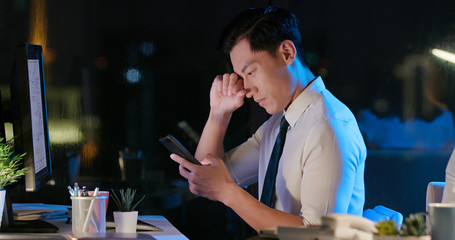 asian businessman feel eye pain
