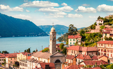 Attractive summer view of Como lake. Captivating morning cityscape of Moltrasio town with spire of...